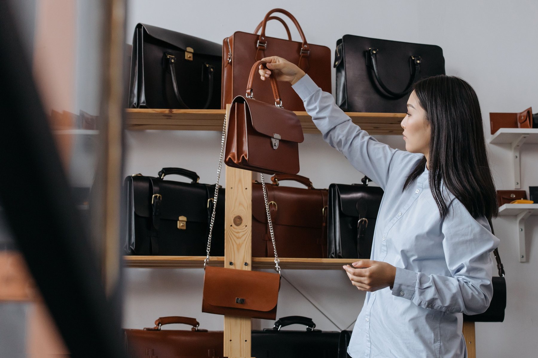 Selection of leather handbags in a modern showroom